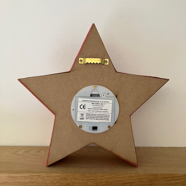 Red Star light at the back, has wall hanging fixture and takes 3 x AAA Batteries