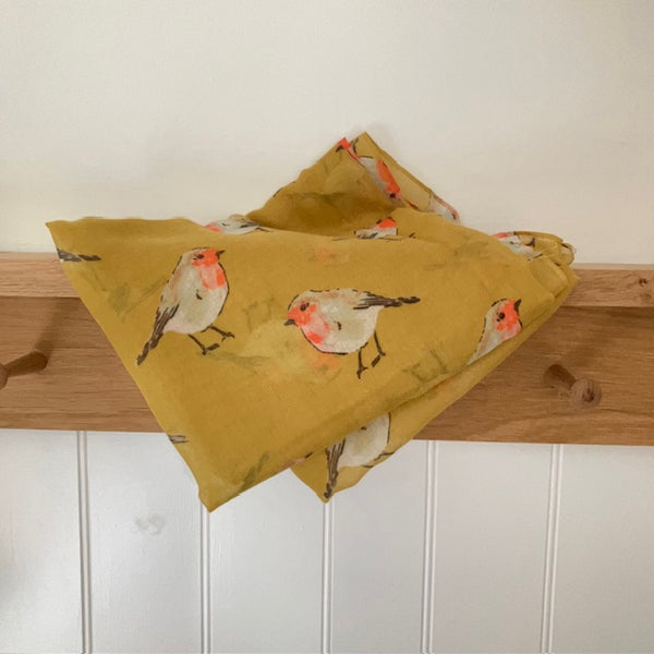 The Robin Scarf Mustard is a super cosy accessory, ideal for Christmas or all year round for any bird enthusiasts