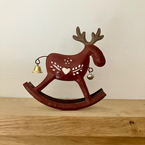 Dark red metal reindeer that rocks with 
pretty Scandinavian paintwork design and bells