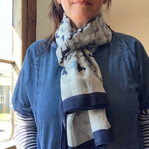 The Rosaline Scarf Blue has a navy border 