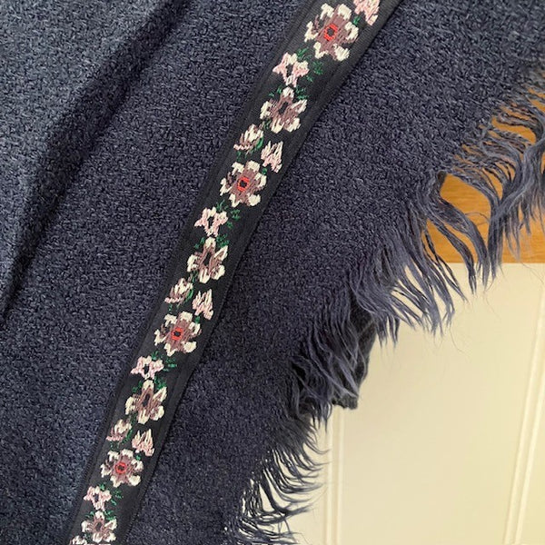 The Samantha Scarf Navy has a pretty floral embroidered ribbing around the edges