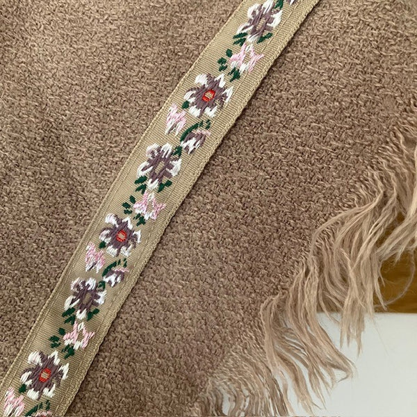 The Samantha Scarf Nude has a floral ribbon round the outer edges