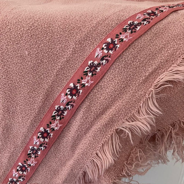 The Samantha Scarf Pink has a pretty floral  embroidered patterned ribbon attached the the edges
