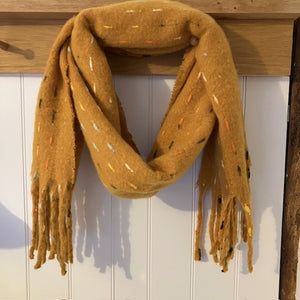 The Theodora Mustard is a super soft large statement scarf that will keep you very cosy and warm