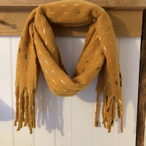 The Theodora Mustard is a super soft large statement scarf that will keep you very cosy and warm