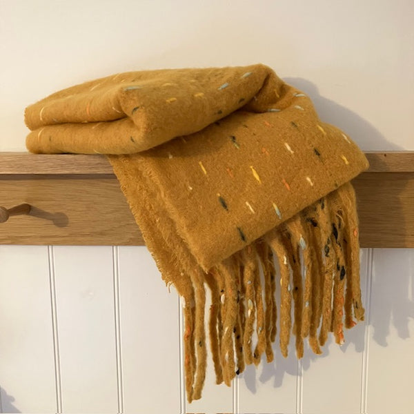 The Theodora Mustard is a super soft large statement scarf that will keep you very cosy and warm