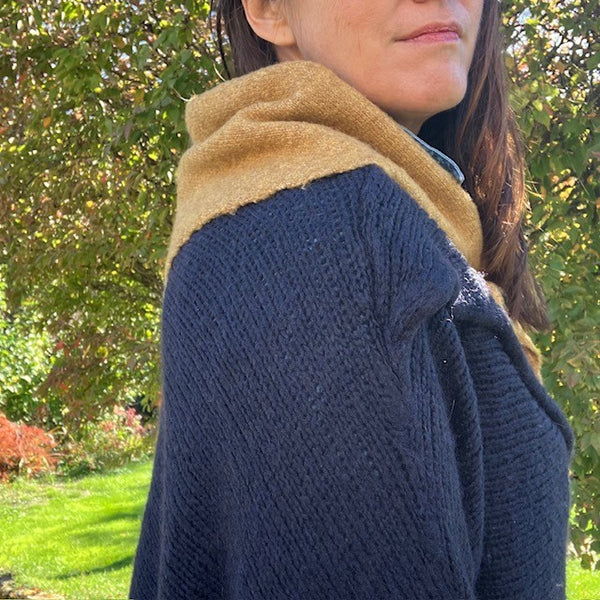 The Tilly Scarf is a soft knit scarf in the on trend triangle shape