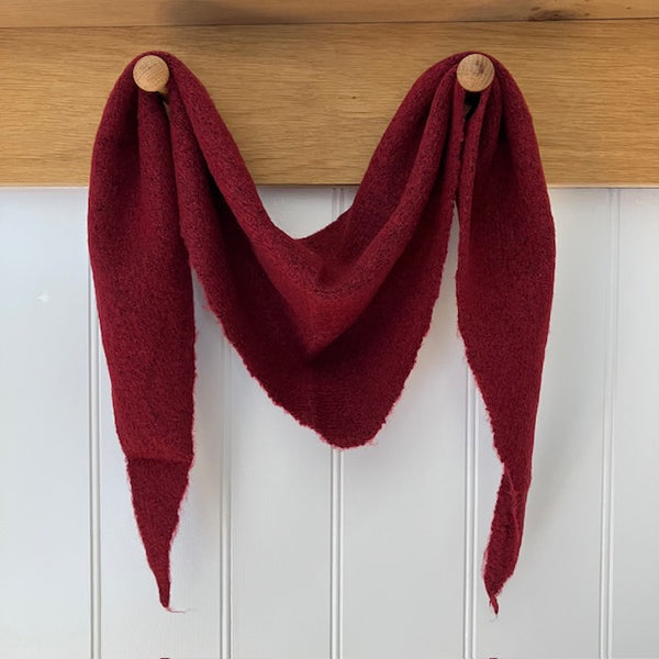 The Tilly Scarf Burgundy in this much sought after triangle shape and small plain knit, is the perfect cosy accessory to elevate your outfit this season