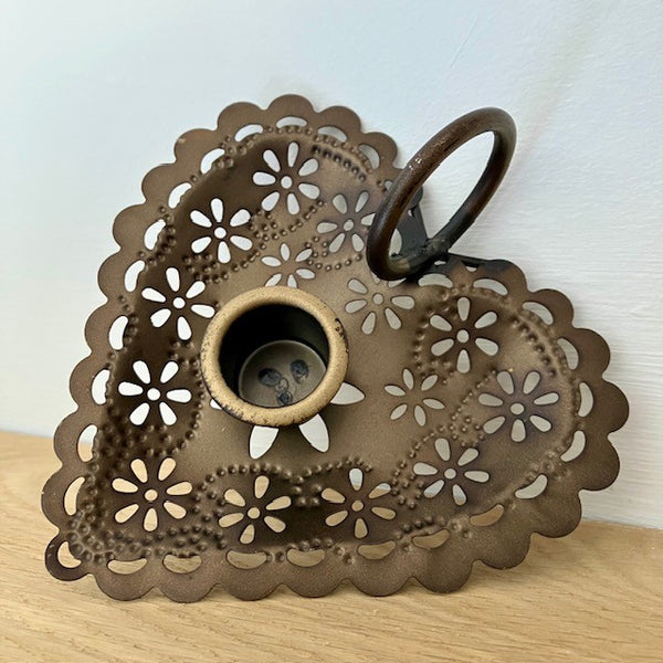 A Wee Willie Winkie candle holder is a small, portable candlestick with a flat saucer base and a single loop finger-grip or side handle