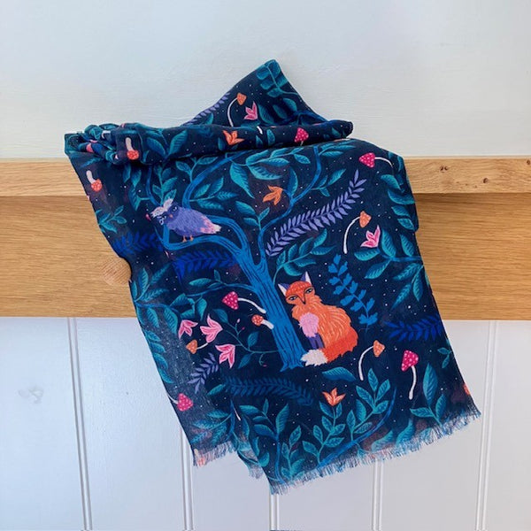 The Winslie Scarf has a fox, owl and toadstool pattern in a mystical forest