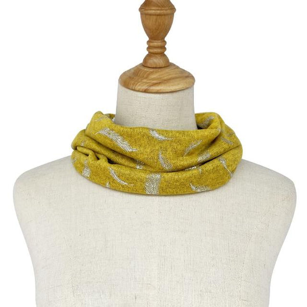 The Abella Snood Silver Feather Mustard is a wonderfully cosy and shimmering eye catching snood